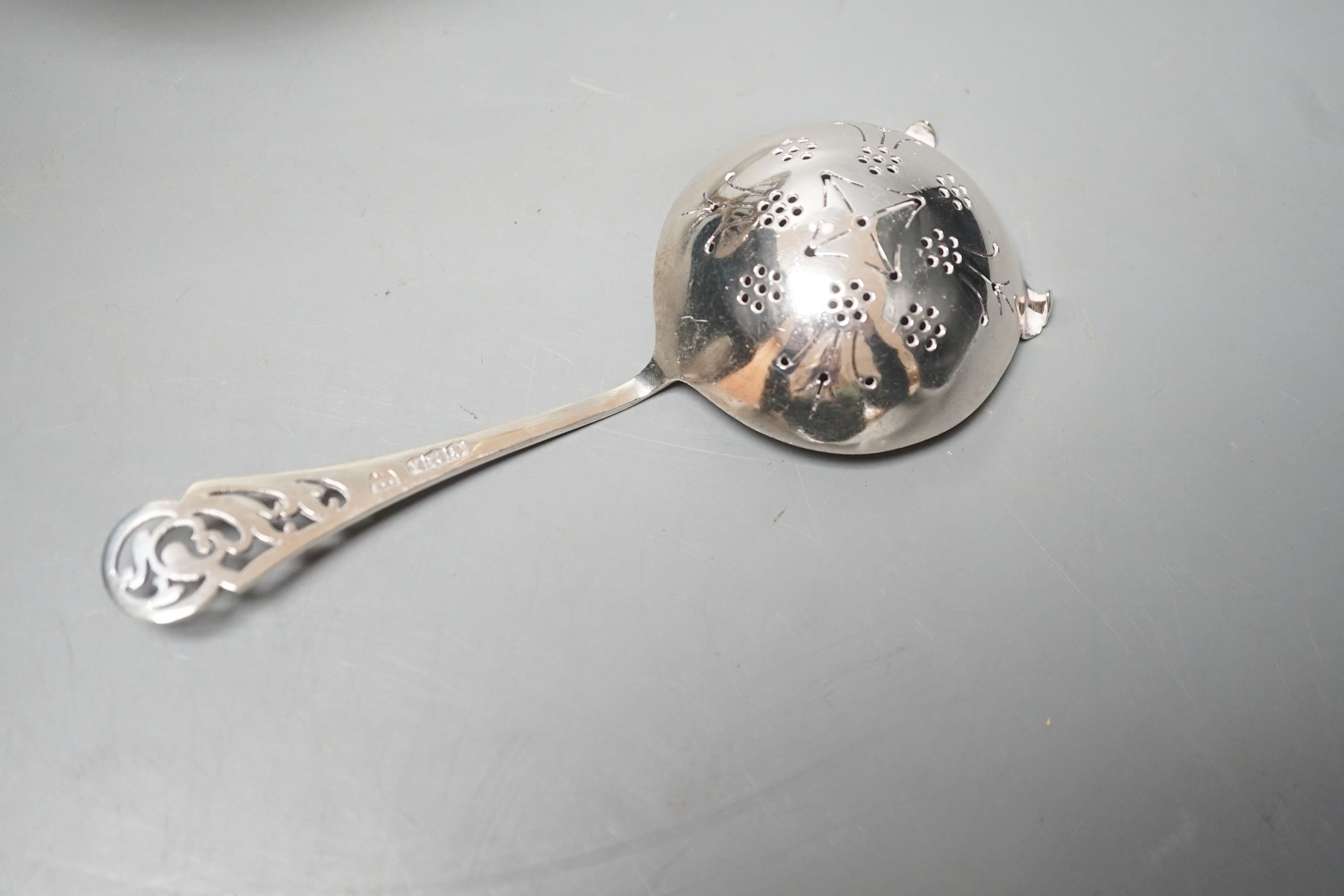 A Edwardian Art Nouveau pierced silver comport, William Hutton & Sons, London, 1903, 15.7cm diameter and a silver sifter spoon, 6.5oz.